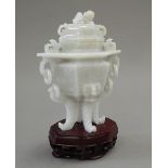 A Chinese jade vase and cover, with stand. 16 cm high overall.