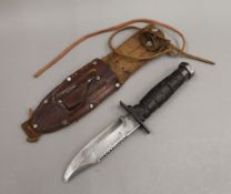 An American K-Bor knife, in sheath. 26 cm long.