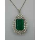 An 18 ct white gold diamond and emerald pendant on a chain. The pendant 4 cm high (15.