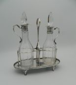 A George III silver and glass two bottle cruet,