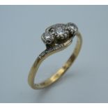 An 18 ct gold three diamond trilogy ring. Ring size R (3.