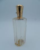 An 18 ct gold topped scent bottle. 9 cm high.