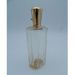 An 18 ct gold topped scent bottle. 9 cm high.