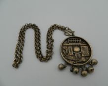 A Chinese pendant on chain. 4 cm diameter.