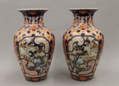 A pair of 19th century Japanese Imari porcelain vases covered overall in well painted intricate