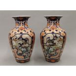 A pair of 19th century Japanese Imari porcelain vases covered overall in well painted intricate