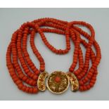 An 18 ct gold mounted five strand coral necklace.