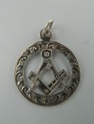 An engraved silver Masonic pendant. 2.5 cm diameter.