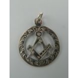 An engraved silver Masonic pendant. 2.5 cm diameter.