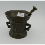 A 17th century bronze pestle and mortar. 11 cm high.