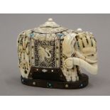 A 19th century Chinese carved ivory model of an elephant, decorated with turquoise,