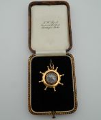 A Victorian 15 ct gold ships wheel fob compass. 3 cm high (6.