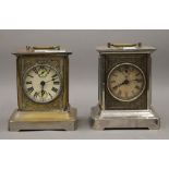 Two carriage alarm clocks. The largest 19 cm high.