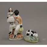 A 19th century Staffordshire figure of a black and white rabbit and a small 19th century
