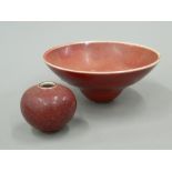 A Chinese Sang De Boeuf porcelain bowl and a small Chinese Sang De Boeuf vase. The former 13.