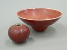 A Chinese Sang De Boeuf porcelain bowl and a small Chinese Sang De Boeuf vase. The former 13.