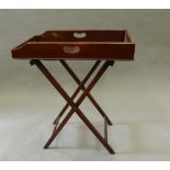 A Victorian mahogany butlers tray on stand. 65 cm long.