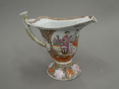 A Chinese porcelain export sauce boat, decorated with figures. 16 cm high.