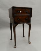 A walnut twin flap bedside table. 75.5 cm high.