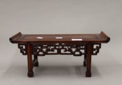 A Chinese carved wooden model of an alter table. 37.5 cm wide.