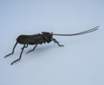 A Japanese articulated bronze model of a locust. 14 cm long.