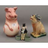 A jug formed as a pig and a piggy bank, together with a small pot mounted with a pig. The former 24.