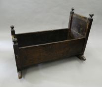 An 18th century oak rocking crib. 91.5 cm long.