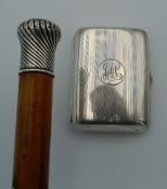 A silver topped walking stick and a silver cigarette case. The walking stick 89 cm long.