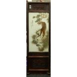 A Chinese porcelain plaque decorated with tigers, foliage and calligraphy, framed.