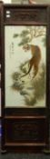 A Chinese porcelain plaque decorated with tigers, foliage and calligraphy, framed.