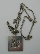 A silver ingot pendant on chain. The pendant 4 cm high (25.