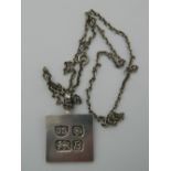 A silver ingot pendant on chain. The pendant 4 cm high (25.