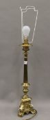A brass alter type table lamp. 74 cm high overall.