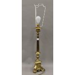 A brass alter type table lamp. 74 cm high overall.