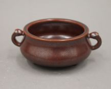 A Chinese red porcelain censer. 13 cm wide.