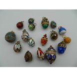 A collection of 17 enamelled Russian egg pendants, the majority in 925 silver.