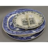 A Victorian Caius College sewing dish and two large Willow pattern plates. The former 30 cm wide.