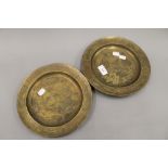 A pair of Asian bronze plates. 25 cm diameter.