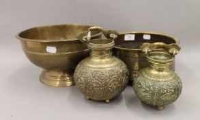 A footed brass bowl with overall engraving,