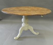 A pine tilt top loo table. 119 cm long.