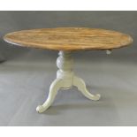 A pine tilt top loo table. 119 cm long.