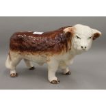 A large porcelain model of a bull. 38 cm long.