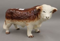 A large porcelain model of a bull. 38 cm long.