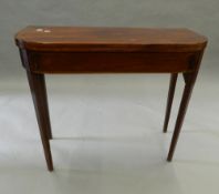 A 19th century inlaid mahogany tea table. 89.5 cm wide.