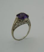 An 18 K white gold and solitaire amethyst ring. Approximately 4 carats. Ring size M.