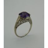 An 18 K white gold and solitaire amethyst ring. Approximately 4 carats. Ring size M.