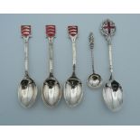 Four silver and enamel spoons (60 grammes), together with another.