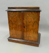 A walnut miniature chest of drawers. 30 cm wide.