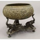An Indian brass singing bowl on stand. 19 cm high.