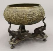 An Indian brass singing bowl on stand. 19 cm high.